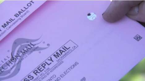 Sacramento California ballot return envelope with hole showing voter selections