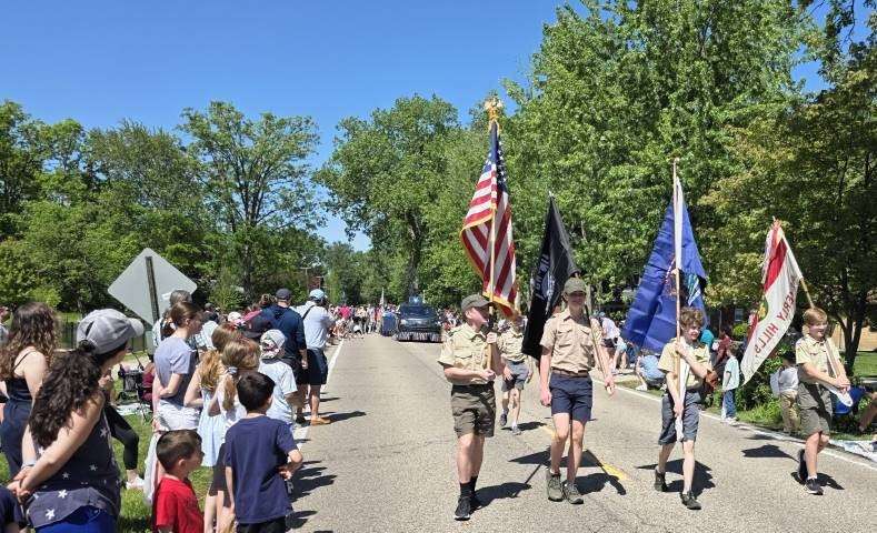 Boy Scouts carrying the American flag and other colors in a Flag Day parade