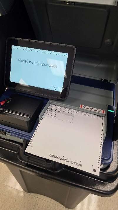 A paper ballot scanner at a polling place